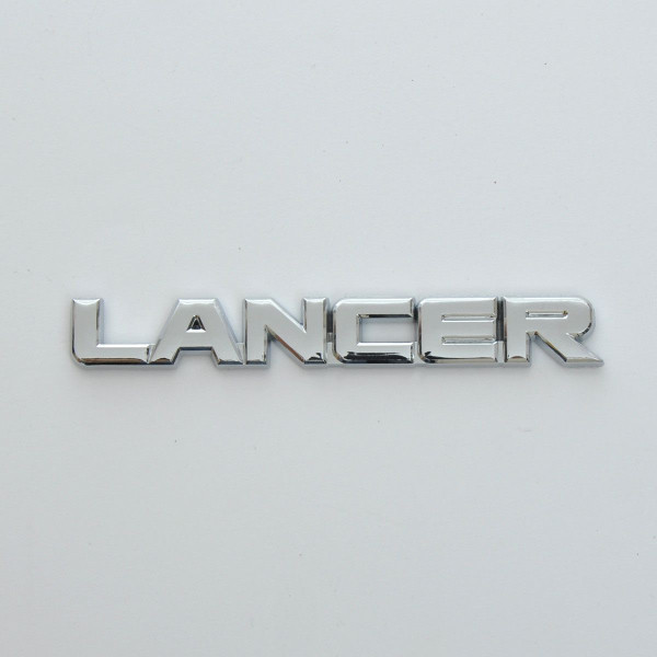 Емблема буквене позначення Lancer скотч 143 x 20 мм